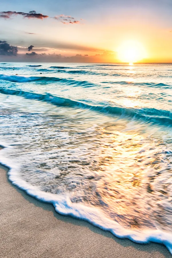 Amino-Blend-IV-Therapy-Treatment Waves washing over a sandy shore during sunset. Schedule your Amino Blend IV Therapy treatment with Marina Fay, PA-C in Aventura-North Miami today.