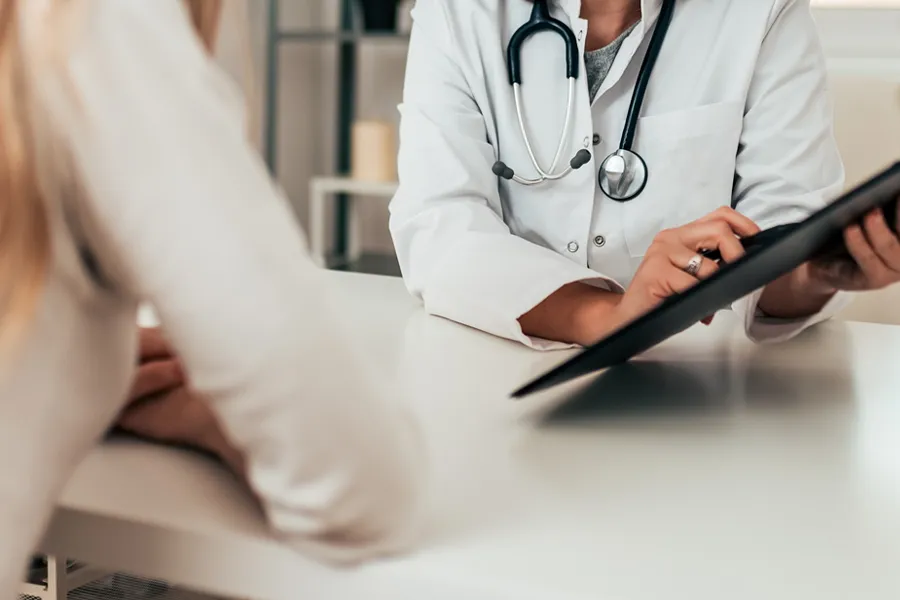 Cognitive-Health-Education-Clinic A clinician goes over information with a patient. Get Cognitive Health Education Treatment from Marina Fay, PA-C in Aventura-North Miami.