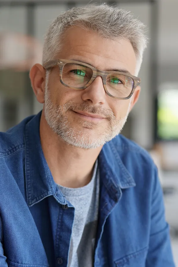 GHK-Cu-Peptide-Treatment A mature man with full gray hair and smooth skin. Get GHK-Cu peptides for skin and hair from Marina Fay, PA-C in Aventura-North Miami.