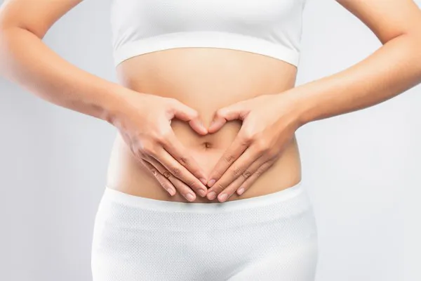 Gut-Repair-Peptides-Clinic A woman holds her hands over her belly in a heart shape. Get Gut Repair Peptides treatment from Marina Fay, PA-C in Aventura-North Miami.