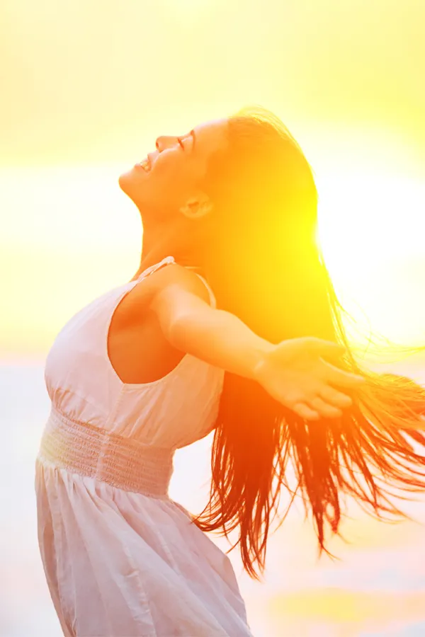 Hydration-IV-Therapy-Treatment A woman opens her arms to the sky at sunrise. Get Hydration IV Therapy from Marina Fay, PA-C in Aventura-North Miami.