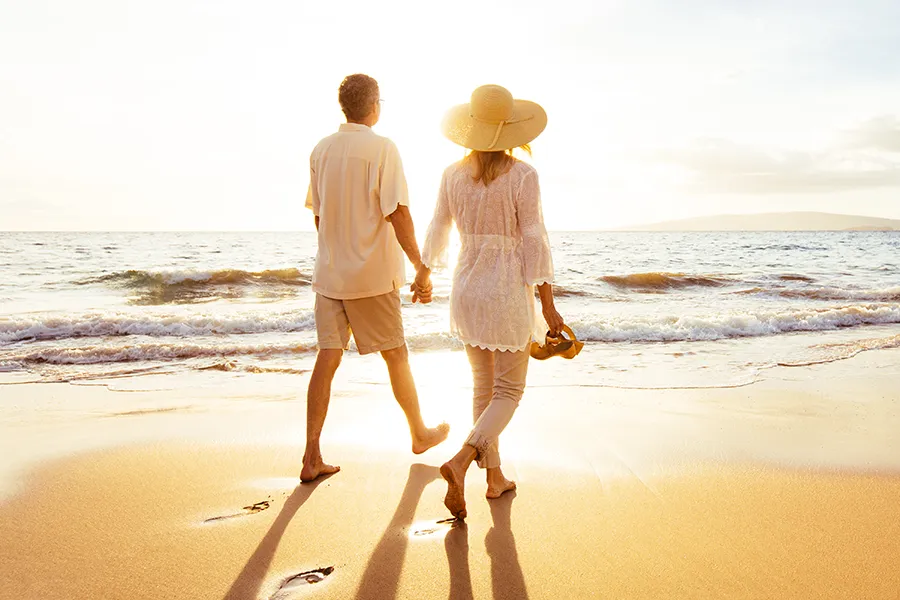Immune-System-Optimization-for-Cognitive-Support-Clinic A middle-aged couple walk along the beach at sunset. Get immune system optimization for cognitive support treatment from Marina Fay, PA-C in Aventura-North Miami.