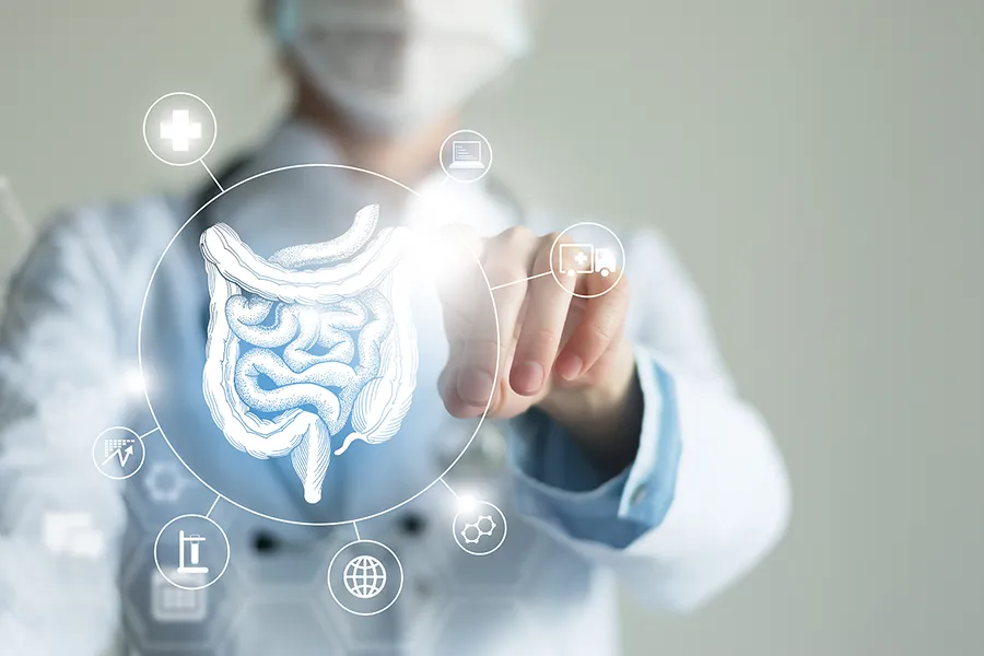 Leaky-Gut-Syndrome-Clinic Marina Fay, PA-C provides advanced Functional Medicine for Leaky Gut Syndrome treatments in Aventura-North Miami, shown by a doctor touching a glowing digital intestinal health display.
