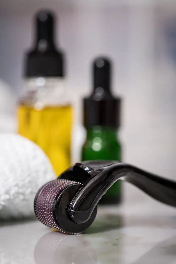 Microneedling-Treatment Close up of oils, a towel, and a microneedling tool used by Marina Fay, PA-C in Aventura-North Miami.