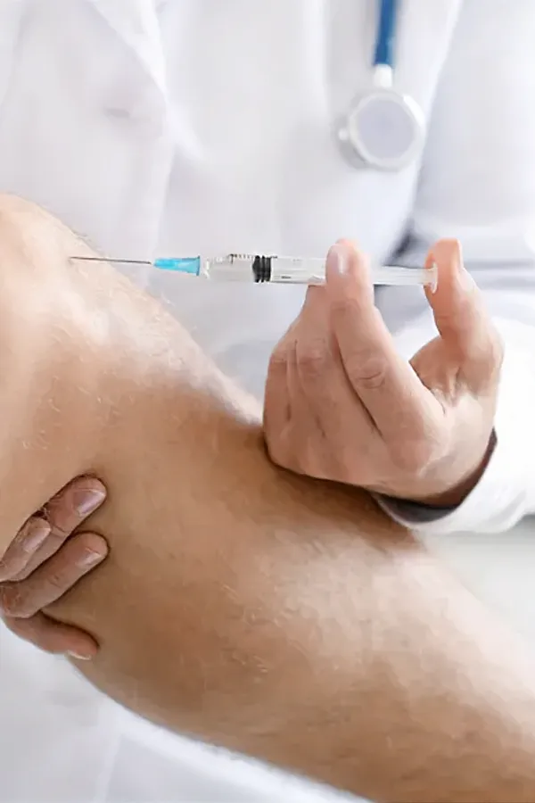 A man gets an injection in his knee. Get PRF Injections for Joint Health from Marina Fay, PA-C in Aventura-North Miami.