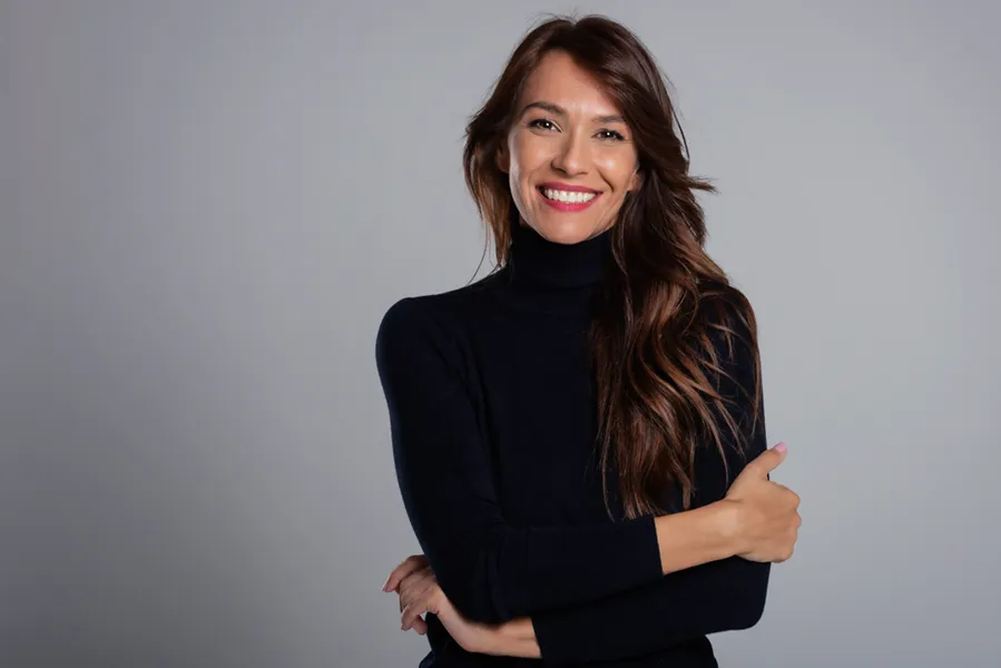 PRF-for-Hair-Restoration-Clinic A woman in a black turtleneck with long, full brown hair. Get PRF hair restoration therapy from Marina Fay, PA-C in Aventura-North Miami.