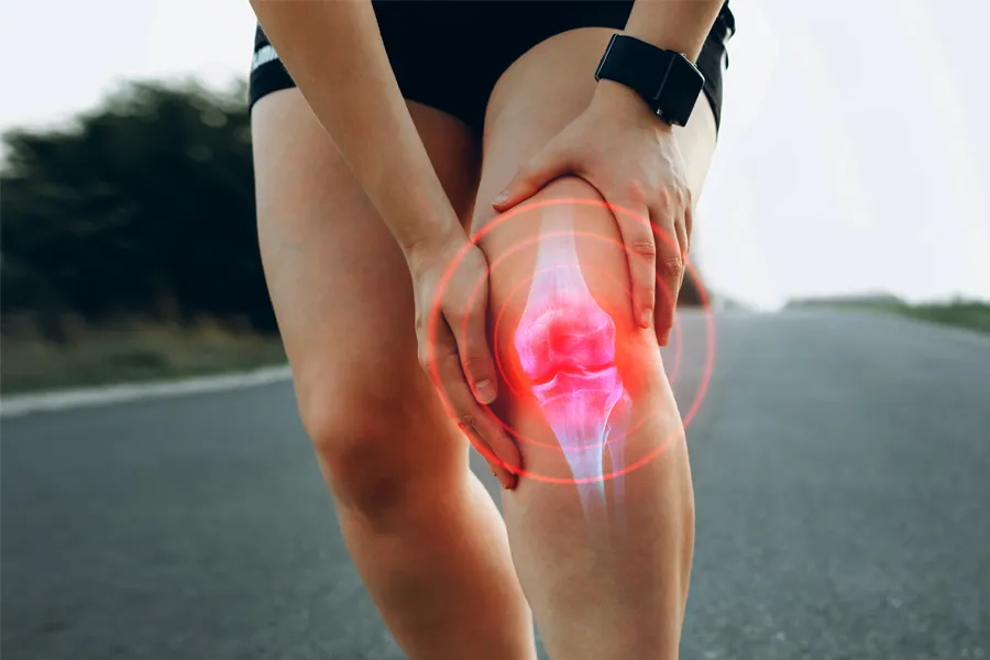 PRP-for-Knee-Injury-Doctor Close up of a female jogger holding her knee with an illustration of the knee joint with red radiating circles indicating pain, which can be relieved with PRP treatment for knee pain from Marina Fay, PA-C in Aventura-North Miami.