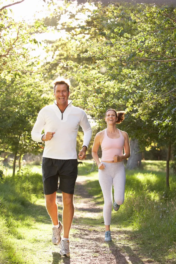 Peptide-Pain-Relief-Treatment A happy middle-aged couple on a run. Get peptide pain relief treatment from Marina Fay, PA-C in Aventura-North Miami.