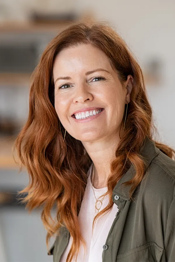 Peptides-for-Hair-Restoration-Treatment A woman with beautiful long red hair smiles due to the success of peptides for hair restoration treatments from Marina Fay, PA-C in Aventura-North Miami.