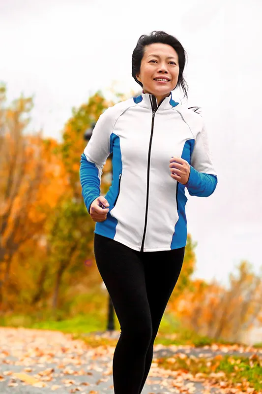 Regenerative-Medicine-for-Inflammation-Treatment A middle-aged asian woman on a run during fall. Get Regenerative Medicine for Inflammation from Marina Fay, PA-C in Aventura-North Miami.