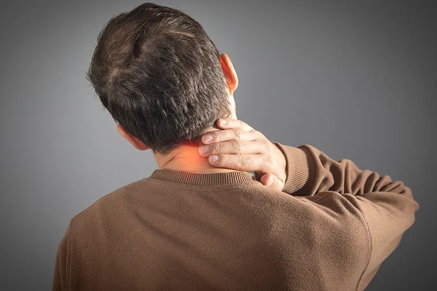 Regenerative-Medicine-for-Neck Pain-Clinic A man rubs his neck in pain. Schedule Regenerative Medicine for Neck Pain from Marina Fay, PA-C in Aventura-North Miami.