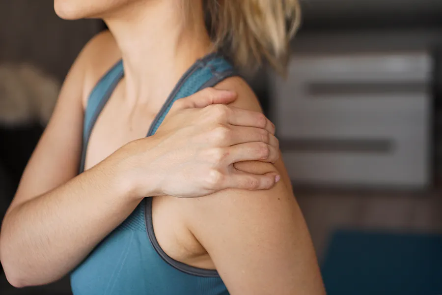 Regenerative-Medicine-for-Sore Muscles-Clinic A man does lunges on the beach. A man sitting on a woman in workout clothes rubs her shoulder in pain. Schedule Regenerative Medicine for Sore Muscles from Marina Fay, PA-C in Aventura-North Miami.
