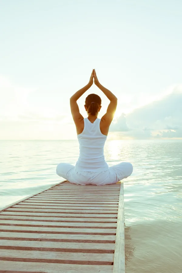 Tissue-Repair-and-Recovery-Peptides-Treatment A woman doing yoga by the ocean. Get Tissue Repair and Recovery Peptide Treatment from Marina Fay, PA-C in Aventura-North Miami.
