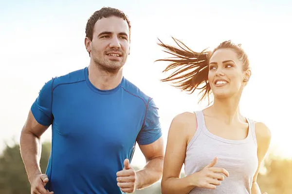Weight-Loss-Resistance-Doctor A couple happily jogging in the sunlight after receiving effective weight loss resistance care from Marina Fay, PA-C in Aventura-North Miami.